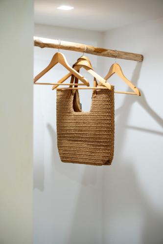 a wicker bag hanging on a rack in a room at Desideri di Puglia in Barletta