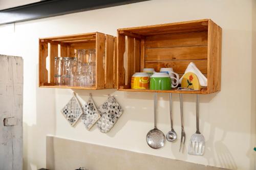a kitchen withoons and utensils on a wall at Desideri di Puglia in Barletta