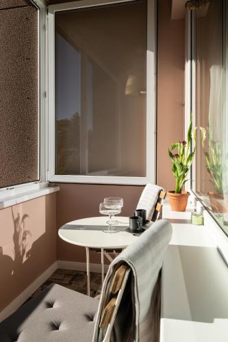 a table and chairs in a room with a window at Sigulda Center with Balcony and Self check-in in Sigulda