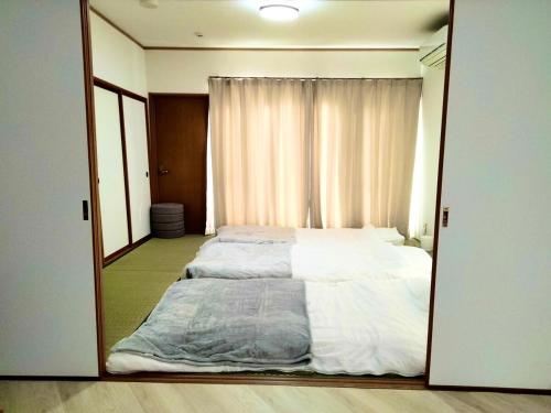Sendai Riverside Retreatにあるベッド