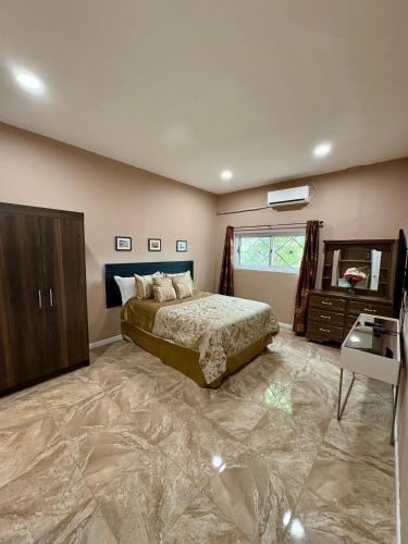 a bedroom with a bed and a dresser and a mirror at Casa en La Trinidad in La Unión