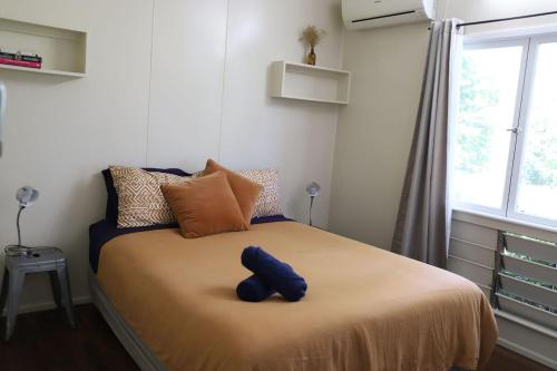 a blue teddy bear sitting on a bed in a room at Mt Bundy Station in Adelaide River