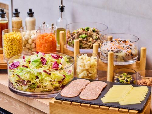a table with many dishes of food on it at Chisun Hotel Kamata in Tokyo