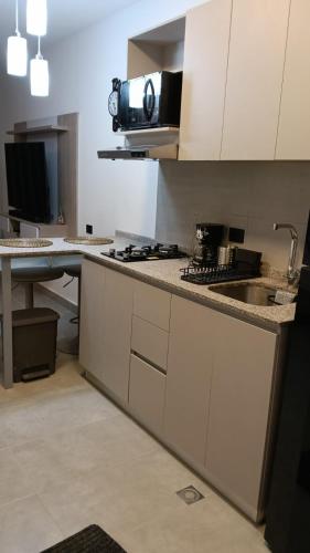 a kitchen with white cabinets and a counter top at Exclusiva Suite Frente al Mar in Santa Marta
