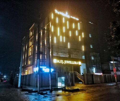 a large building with lights on it at night at THE WHITE IBIS A Unit of S S Manor in Sivasagar