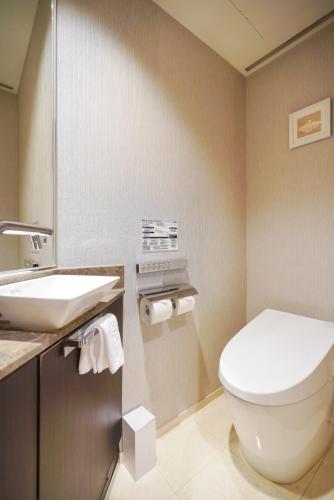 a bathroom with a toilet and a sink at Solaria Nishitetsu Hotel Seoul Myeongdong - Renovated in 2025 in Seoul