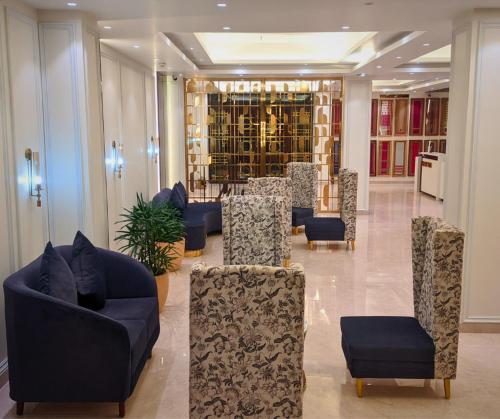 a lobby with couches and chairs in a building at THE WHITE IBIS A Unit of S S Manor in Sivasagar