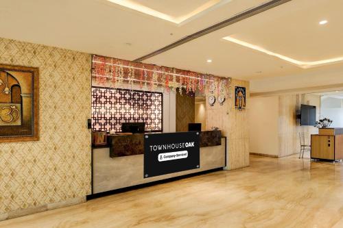 a lobby with a todays pay counter in a building at Super Townhouse Oak Anu Hospital Elur Road Formerly Grand Tankasala in Gunadala