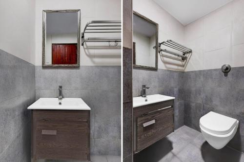 a bathroom with a toilet and a sink and a mirror at Super Townhouse Oak Anu Hospital Elur Road Formerly Grand Tankasala in Gunadala
