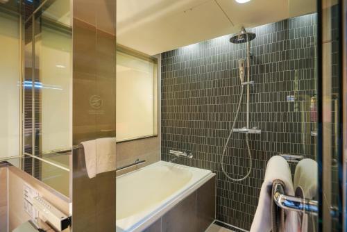 a bathroom with a tub and a sink and a shower at Solaria Nishitetsu Hotel Seoul Myeongdong - Renovated in 2025 in Seoul