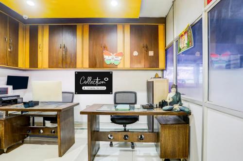an office with two desks and a person sitting at a desk at Super Collection O Begumpet Formerly Alpine Glow Sunrise in Hyderabad