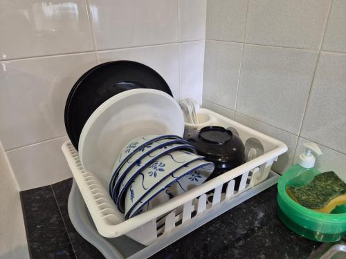 a dish drying rack with dishes in a kitchen at 4-10pax BAYU BEACH 2R2B PRIVATE BEACH, WATERSPORT, Pool, Bbq, Wifi, 50"TV in Port Dickson