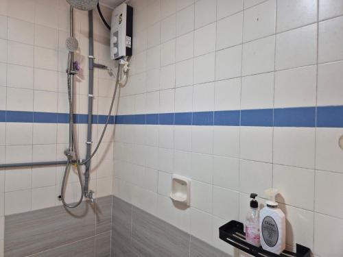 a bathroom with a shower with blue and white tiles at 4-10pax BAYU BEACH 2R2B PRIVATE BEACH, WATERSPORT, Pool, Bbq, Wifi, 50"TV in Port Dickson