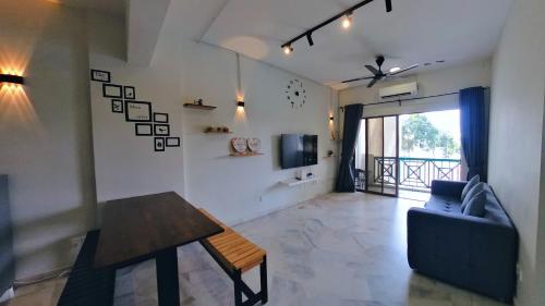 a living room with a couch and a table at 4-10pax BAYU BEACH 2R2B PRIVATE BEACH, WATERSPORT, Pool, Bbq, Wifi, 50"TV in Port Dickson