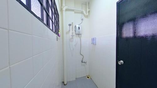 a bathroom with a shower with a black door at 4-10pax BAYU BEACH 2R2B PRIVATE BEACH, WATERSPORT, Pool, Bbq, Wifi, 50"TV in Port Dickson