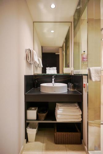 a bathroom with a sink and a mirror at Solaria Nishitetsu Hotel Seoul Myeongdong - Renovated in 2025 in Seoul