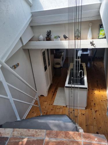 a view from the top of a room with a staircase at les filatures in Saint-Vincent-de-Reins