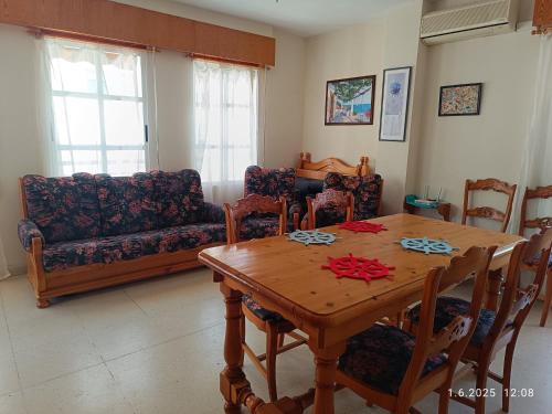 a living room with a table and a couch at penthouse la mata in La Mata