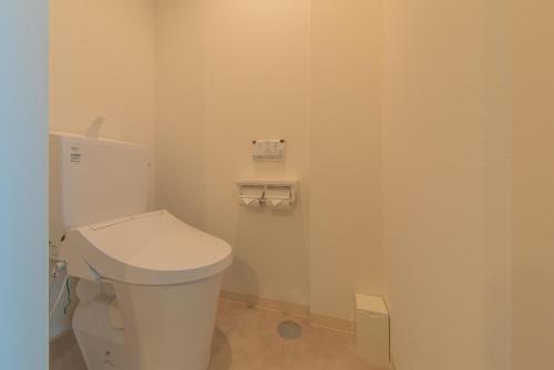 a bathroom with a white toilet in a room at LEU Guest House in Nasushiobara