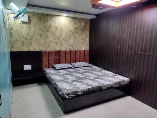 a small bedroom with a bed in a room at HOTEL AYUSH INTERNATIONAL in Balasore