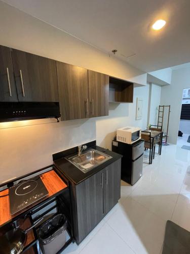 a kitchen with a stove and a sink in it at Sojourn Escape in Sampong