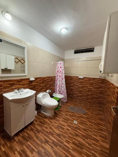 a bathroom with a sink and a toilet and a mirror at Casa Tomas 2 in Villa Unión