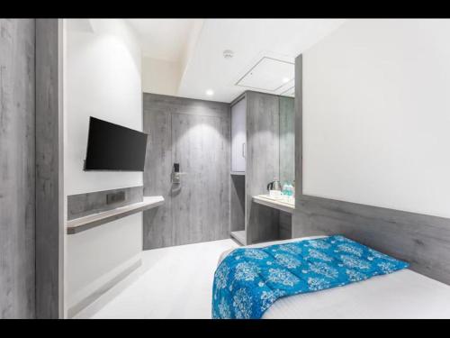 a bedroom with a bed and a tv in it at Hotel Supreme Comforts - Mumbai Airport in Mumbai