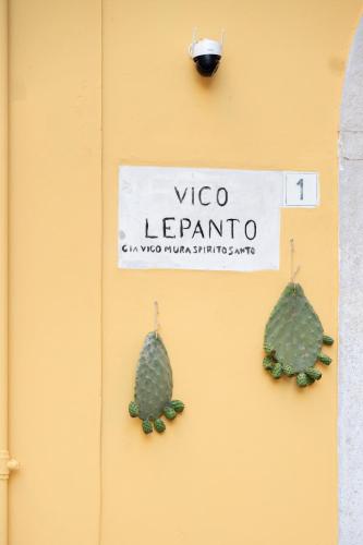 a cactus earrings are hanging on a yellow wall at Desideri di Puglia in Barletta