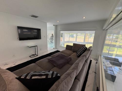 a living room with a couch and a flat screen tv at The Monochrome Villa in Fort Lauderdale