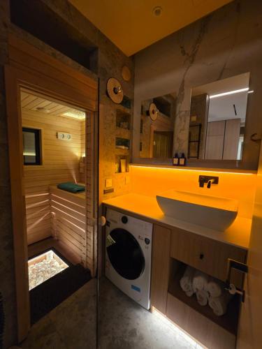 a bathroom with a sink and a washing machine at Chill out Spa Studio in Kotor