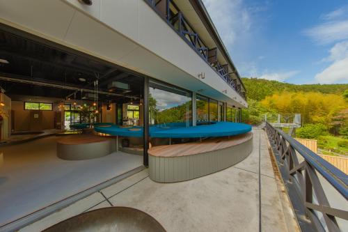 a building with blue tables on the balcony at LEU Guest House in Nasushiobara