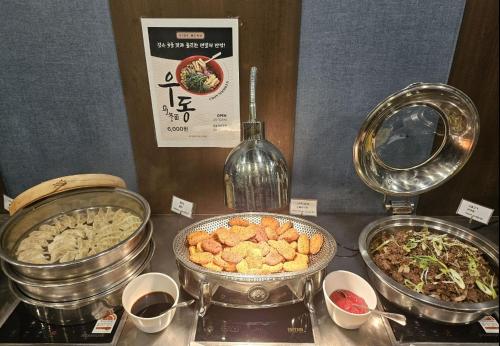 a buffet with different types of food on a table at With Stay Jeju Hotel in Jeju