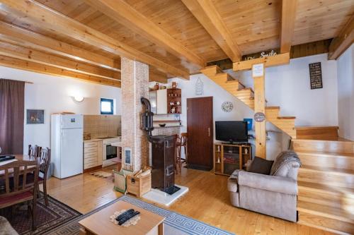 a large living room with a staircase in a house at Guest house Holiday in Žabljak