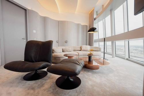 a living room with a couch and two chairs at Vilnius TV Tower Apartments DEBESYS in Vilnius