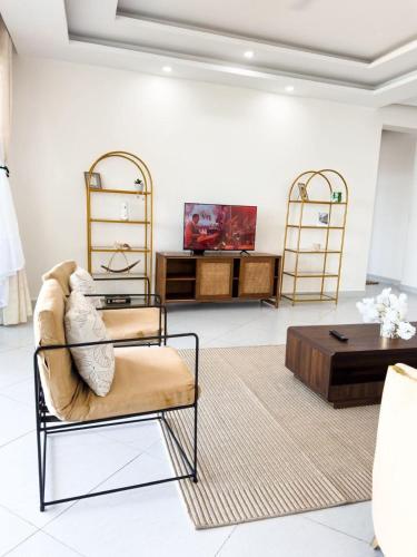 a living room with two chairs and a table at Pink Maraboi Resort in Kisumu