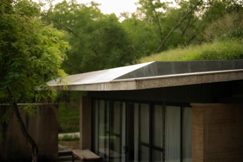 a metal roof on a house with trees in the background at Walden in Nohan