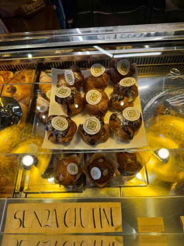 a display case with a bunch of donuts on display at Affittacamere Il Cuore Verde in Norcia