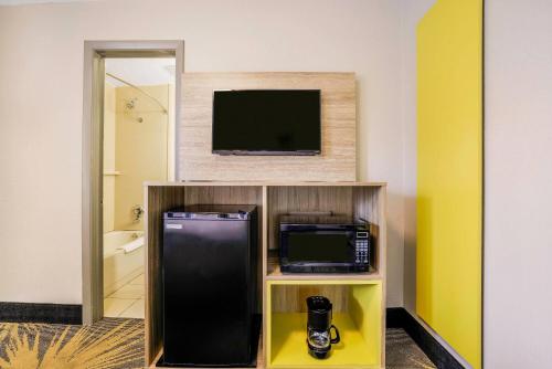 a hotel room with a tv and a microwave at Days Inn by Wyndham Cortez in Cortez