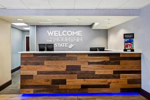 a welcome to the mountain state sign in a lobby at Hampton Inn Princeton in Princeton