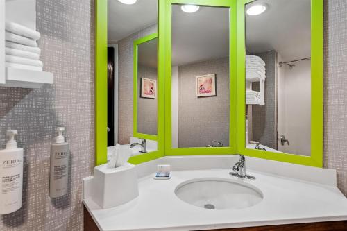 a bathroom with a sink with green accents at Hampton Inn Princeton in Princeton