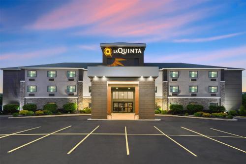 a rendering of the front of a hotel with a parking lot at La Quinta by Wyndham Batavia in Batavia