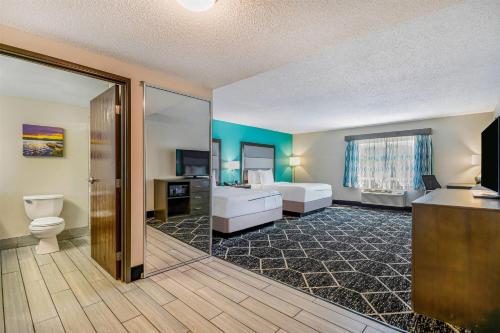 a large bathroom with a toilet and a sink at La Quinta by Wyndham Batavia in Batavia