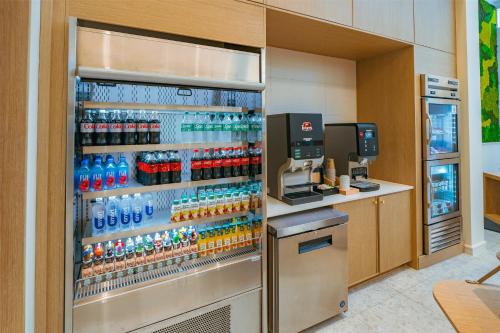 a refrigerator filled with lots of bottles of water at Embassy Suites By Hilton Orlando Sunset Walk in Kissimmee