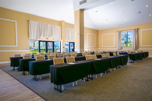 a room with rows of tables and chairs at Embassy Suites By Hilton Orlando Sunset Walk in Kissimmee