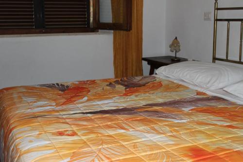 a bed with a colorful blanket on top of it at Villa Lilia by Let in Siena