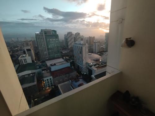 a view of a city skyline from a window at EK's Place in Manila