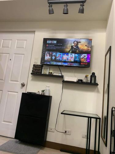 a room with a computer monitor on a wall at EK's Place in Manila