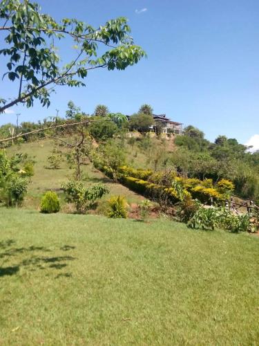 a house on top of a hill with a green field at Pink Maraboi Resort in Kisumu