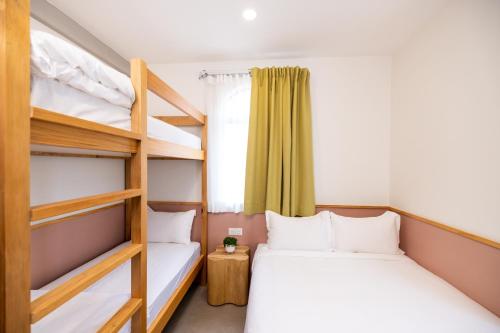 a bedroom with two bunk beds and a window at mu petite in Ipoh