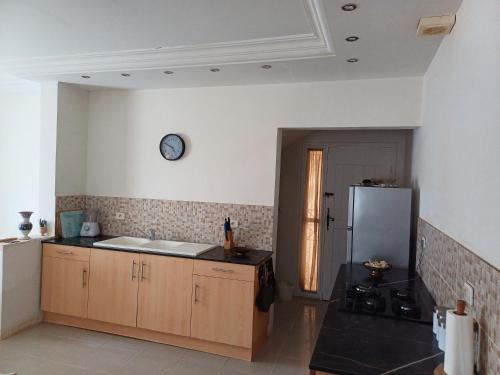 a kitchen with a sink and a refrigerator at Baraka in Aghīr